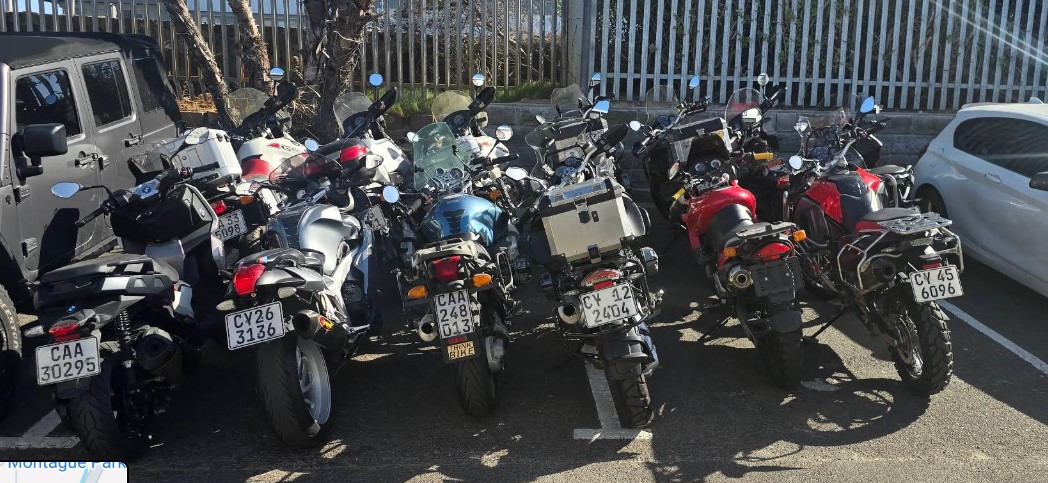 Row of BMW motorcycles lined up inside Shane's workshop, ready for servicing